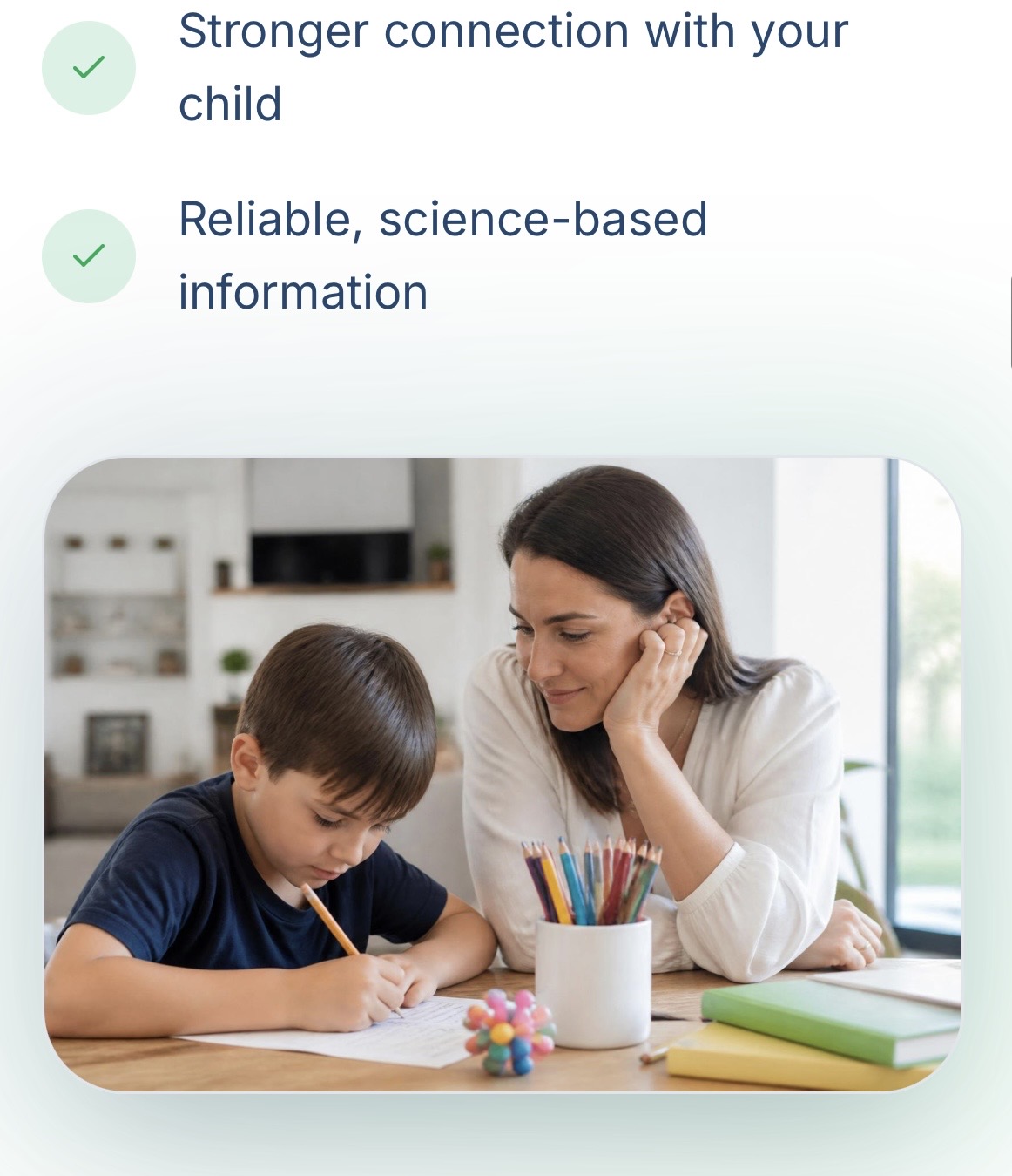 Calm mother watching her child do homework peacefully